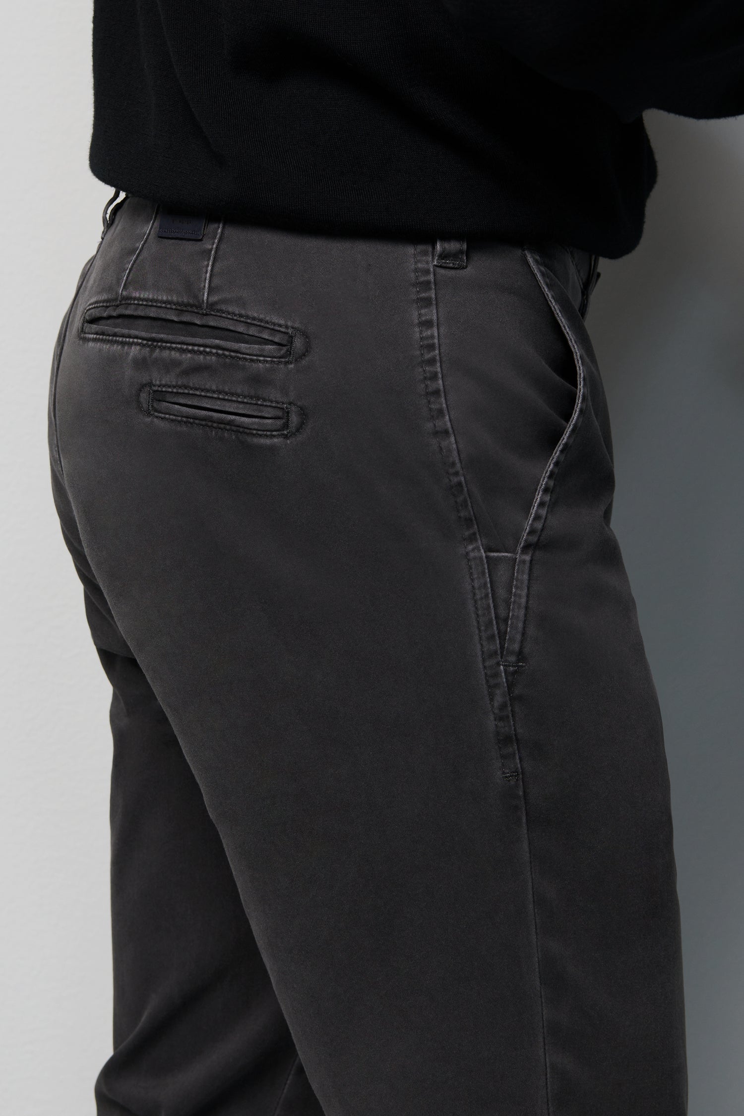 Dark gray pants with a plain background